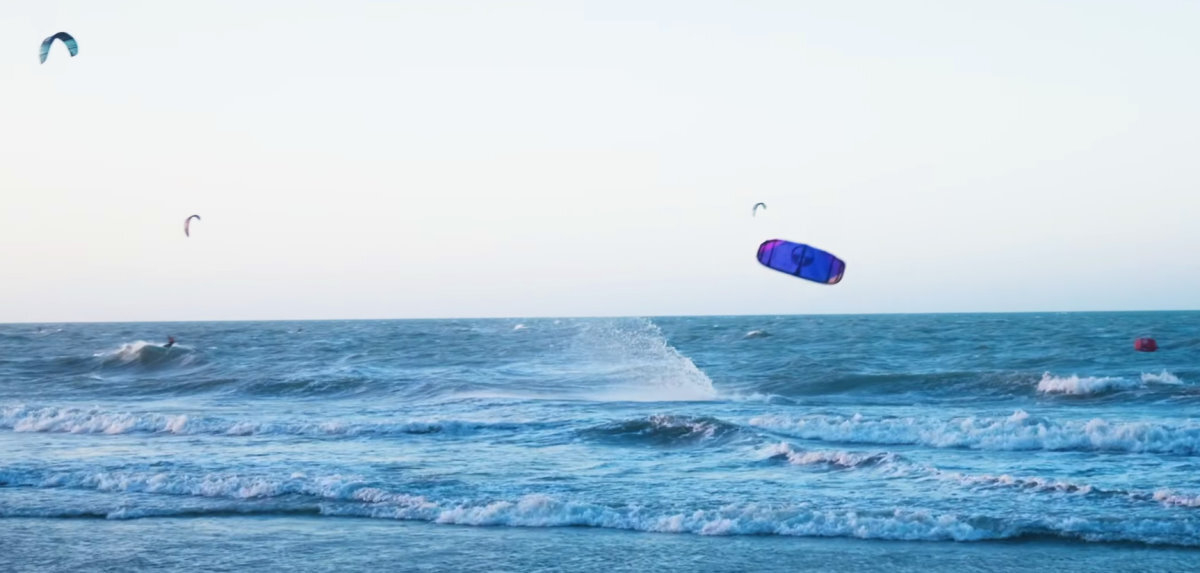 A kiteboarder splashes down hard as the kite crashes into the water.