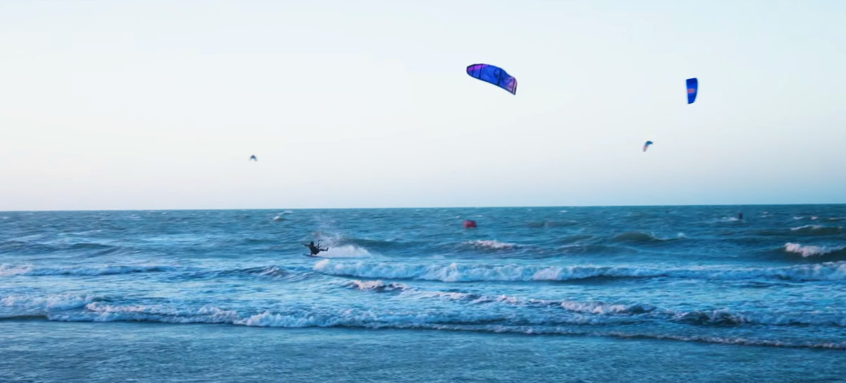 A kiteboarder falls off his board as his kite crashes into the water.