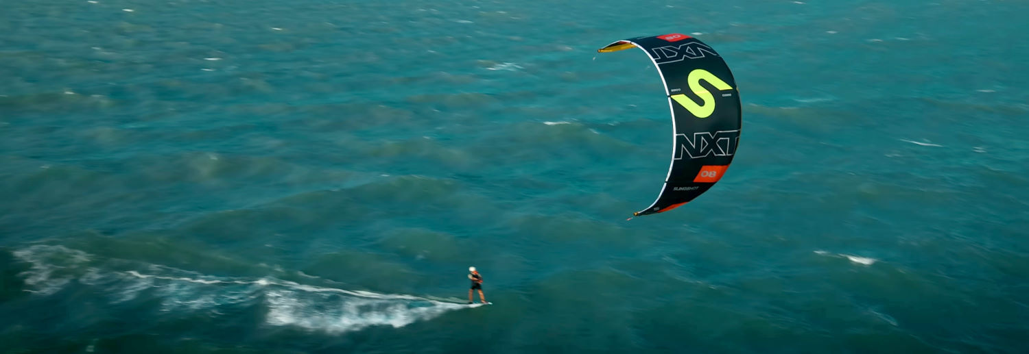 The Slingshot Code NXT V2 is easy to use. A kiteboarder zips across the water behind the Slingshot Code NXT V2 kite.