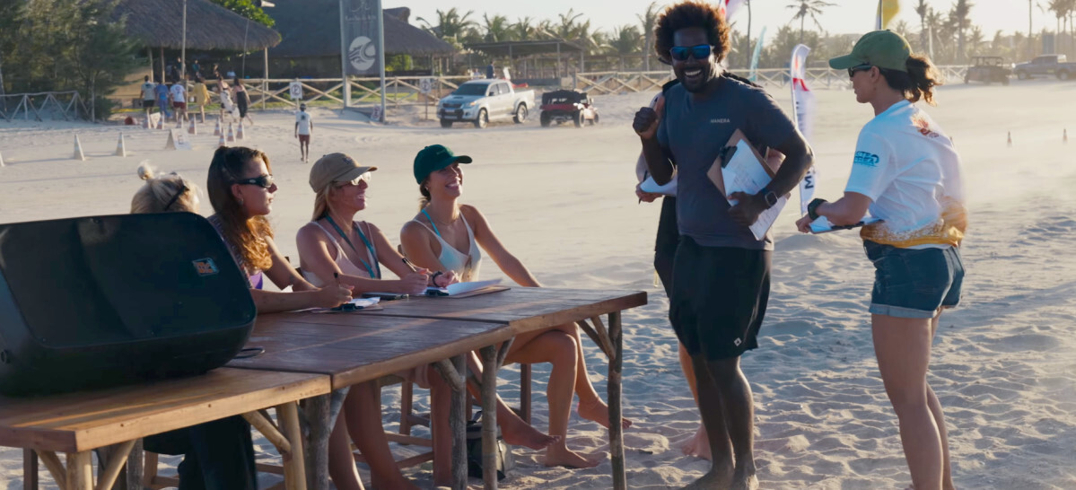 Everyone's registered- let's get boosting! The competition registration table with event organizer Mitu standing nearby.