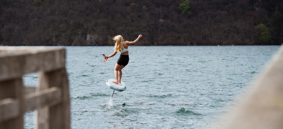 Woman riding the Waydoo Pro Plus eFoil in open water