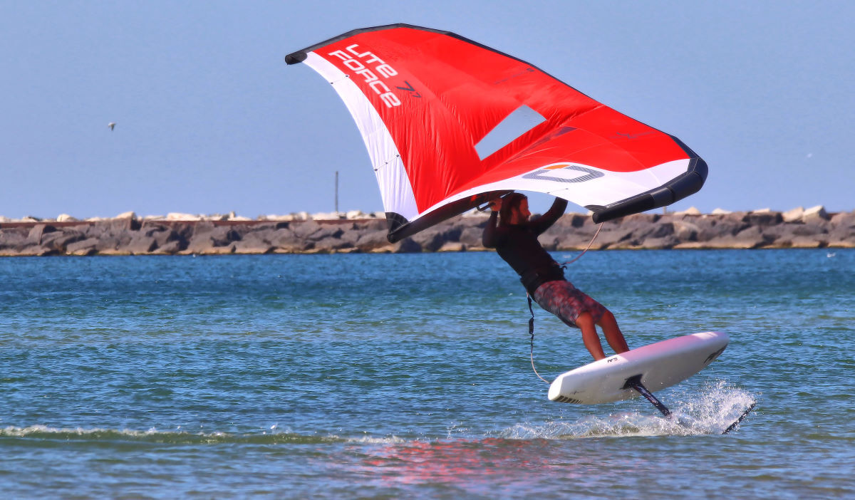 Tucker banks hard into a turn while wing foiling.