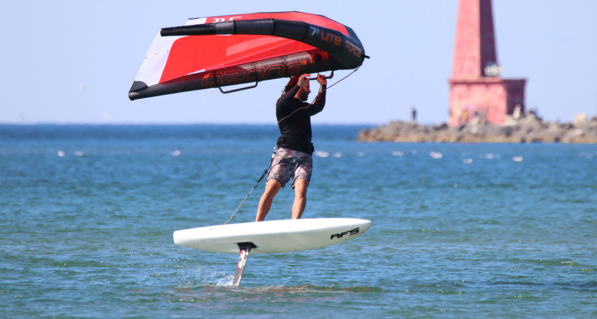 Tucker wing foils in front of a lighthouse.