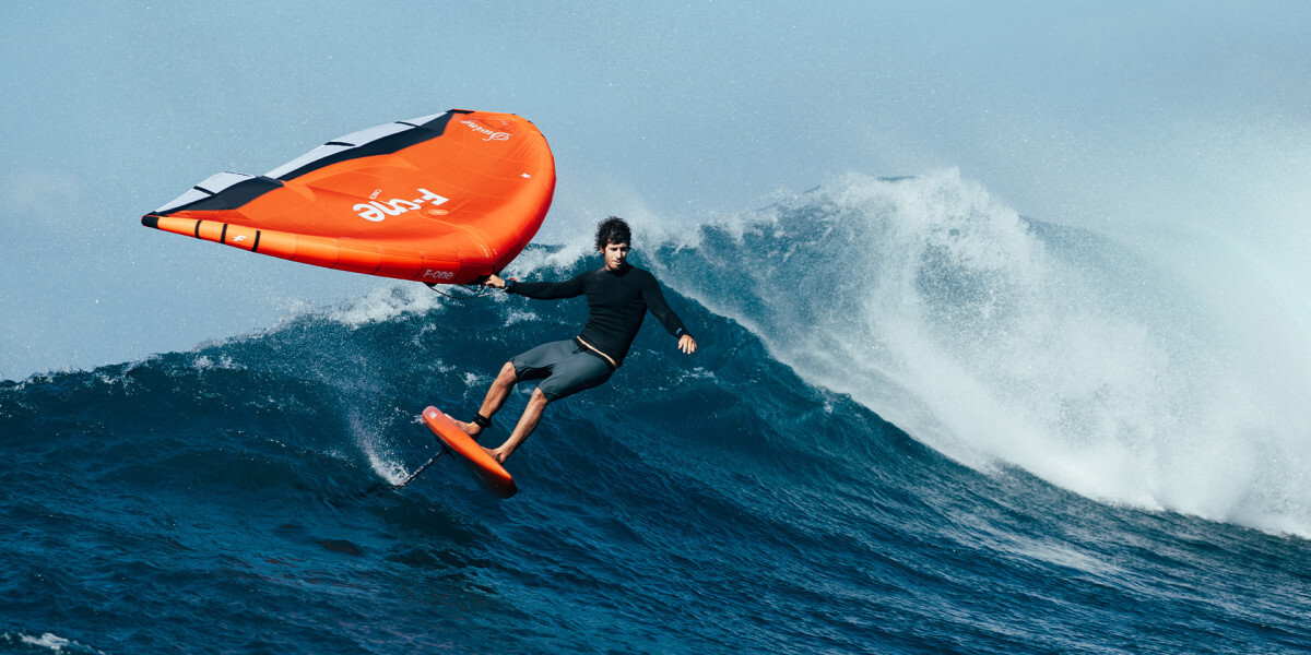 Welcome to the playground, kids! a foil surfer riding a wave with F-One wing gear